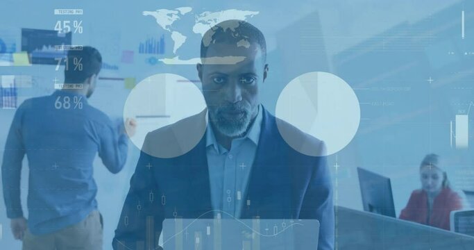 Animation of infographic interface over african american mature businessman in suit using laptop