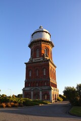 Picturesque view of the iconic Invercargill Water Tower in New Zealand, against a vibrant blue sky