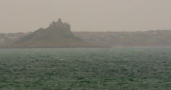 distant misty shot of Saint Michael's mount taken at mousehole Cornwall