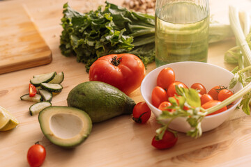 Fresh vegetables in white plates and on a wooden table.