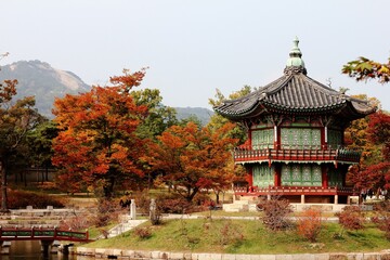 View of Hyangwonjeong Pavilion surrounded by colorful trees. Gyeongbokgung Palace, South Korea.