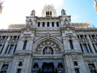 Low angle facade of Cybele Palace with intricate ornamentation in Madrid, Spain