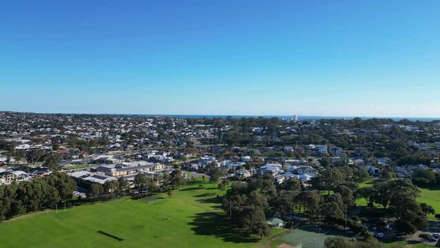 Ascending drone footage of Lake Gwelup and suburb houses on a sunny day in Paine Court, Australia