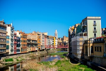 Fototapeta na wymiar Girona city in Catalonia, Spain, featuring a winding river snaking through the urban landscape