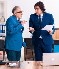 Young and old employees working together in the office