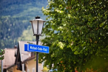 Vibrant street sign displaying the name 'Michael-Ende-Platz' against buildings