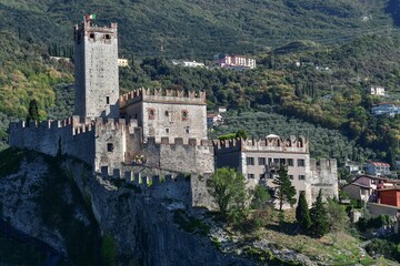Fototapeta na wymiar Stunning Malcesine Castle, surrounded by lush green hills and mountains in Italy