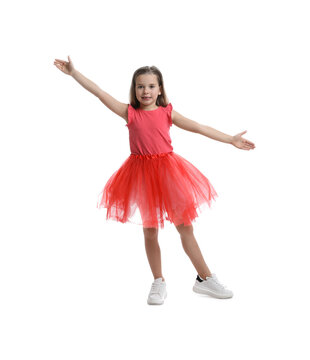 Cute little girl in tutu skirt dancing on white background