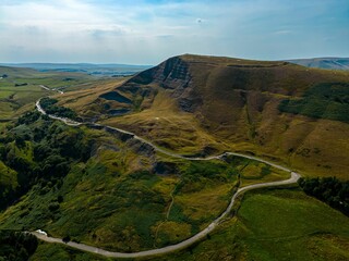 Aerial view of the Hills of Mam Tor in the Peak District winding road snaking through a valley