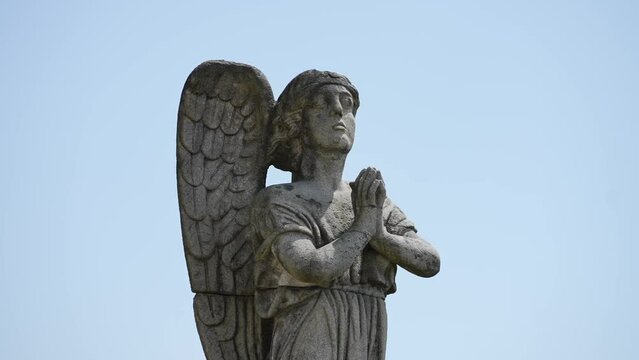 Praying stone angel statue with intricate wings at Sameiro Sanctuary