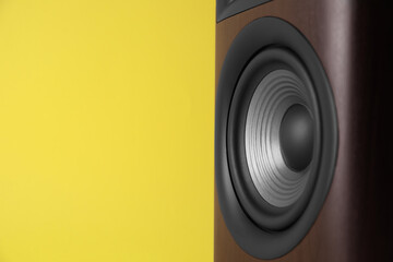 One wooden sound speaker on yellow background, closeup. Space for text - obrazy, fototapety, plakaty