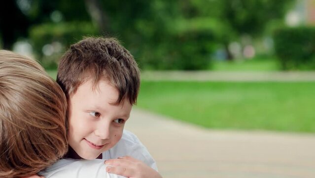 Young mother with son hug in nature. Family meeting mom with kid in park. Happy boy child runs to mom in summer park, hugging mom. Happy family. Kid mom have fun playing outdoor. Family, child walk