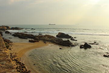 Huge cargo ship and the waves crashing on the shore of Galle fort, Sri Lanka