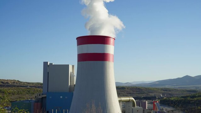 Coal fired power station plant Smoke Steam Chimney rural sunny clear sky day