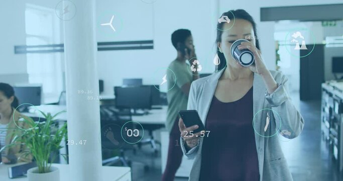 Animation of icons over asian woman drinking coffee and using cellphone while walking in office