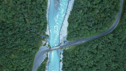 Aerial top view of a river meandering through lush green landscape - Powered by Adobe
