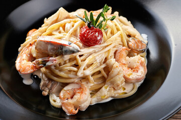 spaghetti with shrimp on a black plate Fettuccine