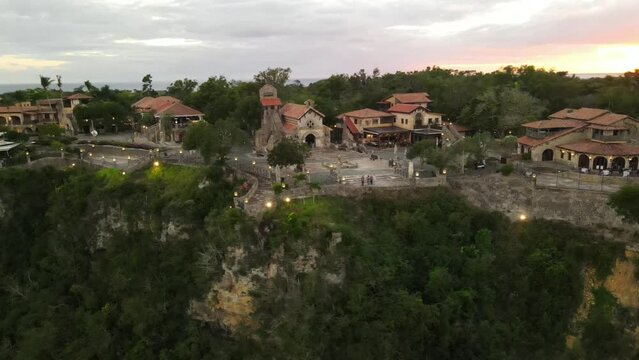 Aerial view of Altos de Chavon with its green areas and cloudy sky at sunset.