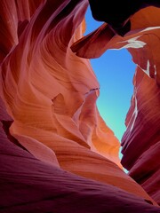 Bright sunbeams shining through the crevice of red sandstone cliffs in Antelope Canyon, Arizona