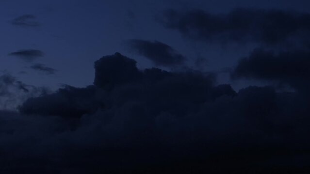 Like hostile invader dark cloud moves silently across blue skyline. Aerial
