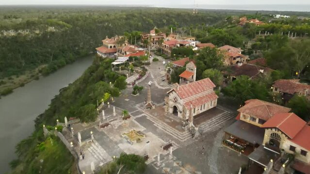 Aerial view of Altos de Chavon with its green areas and cloudy sky at sunset.