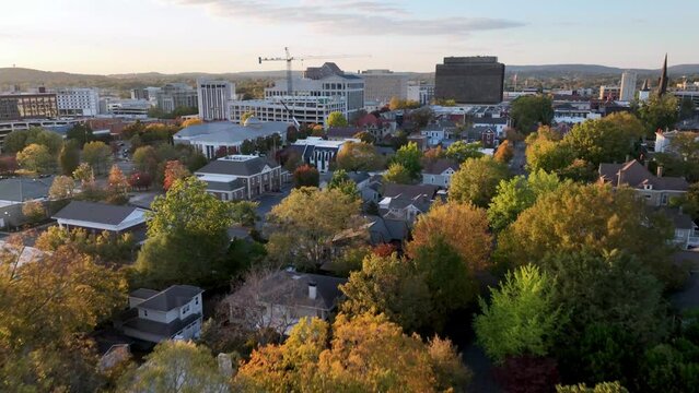 aerial fast push into huntsville alabama skyline with autumn and fall leaf color