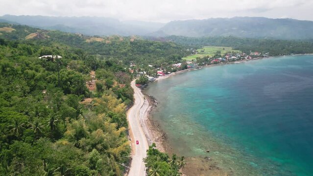 Tropical green scenery coastal road and mountains in background, Philippines
