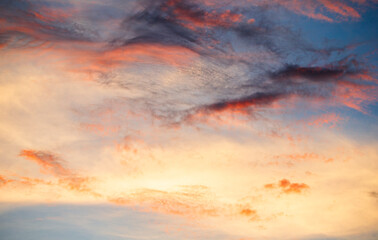 Cloudscape, Colored Clouds at Sunset near the Ocean on a Blue Sky