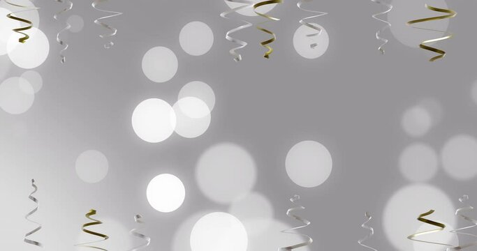 Animation of party streamers and spots of light on grey background