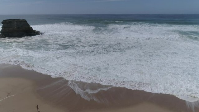 waves crashing on rocky coastline. Blue ocean, wave and impact power.