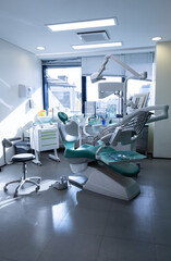 Dental equipment in dentist office in new modern dental clinic room. Background of dental chair and accessories.  - obrazy, fototapety, plakaty