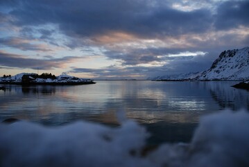 Backdrop of snow-capped mountains illuminated by the brilliant rays of the sun.