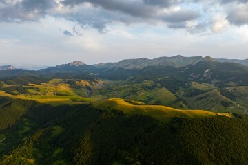 Aerial view of green hills at sunset