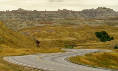 Fototapeta premium the winding road winds through a landscape full of green hills