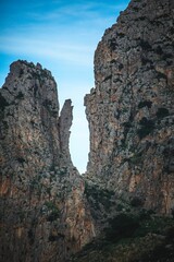 two tall mountains near each other with the top half of a hill in the fore