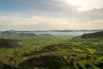 Stunning panoramic view of Ibb, Yemen, featuring a vast valley surrounded by majestic mountains