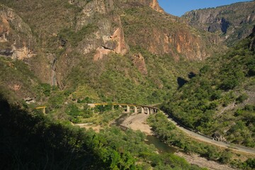 Scenic view of a train track surrounded by majestic mountains. Northwestern Mexico.