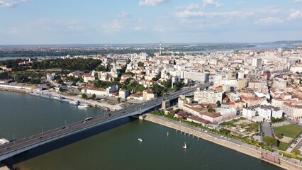 Obraz premium Aerial view of a cityscape with the Branko bridge over a river between buildings