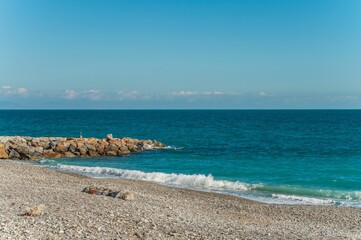 Fototapeta na wymiar Stunning beach with beautiful blue waters in Noli, Liguria, Italy