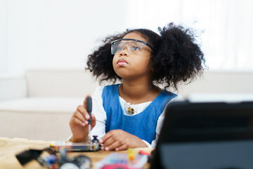 Little girl learning about electronics.