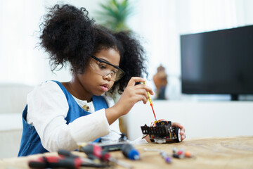 Little girl learning about electronics.