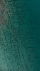 Aerial view of an idyllic beachfront landscape along the shore of the ocean