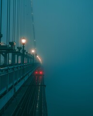 Fototapeta premium Modern passenger train traveling along a bridge illuminated by the moonlight at night