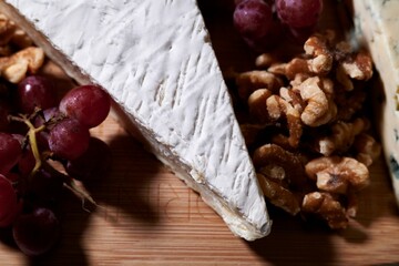 Cutting board with a selection of grapes and cheese on display