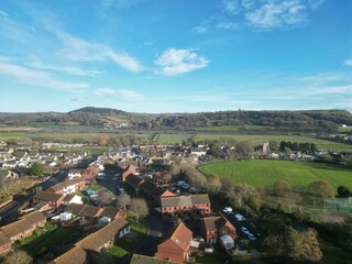 Fototapeta premium Aerial view of rural houses in a green field near the sea in Seaton, Devon