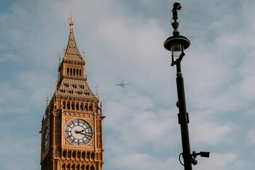 Light pole with two security cameras, overlooking the iconic Big Ben clock tower in London, England