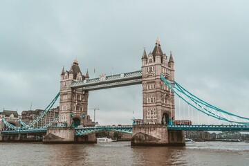 Scenic Tower Bridge in London with waterscape on a cloudy day