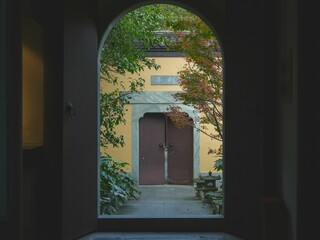 Open door at the end of a dark, narrow hallway