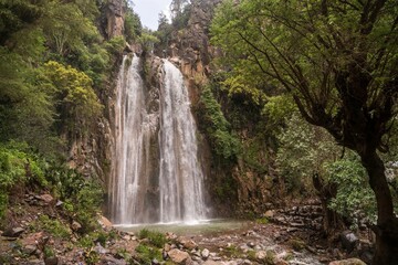 Naklejka na ściany i meble Natural view of the Wadi Banna waterfall in Al-Seddah, Yemen