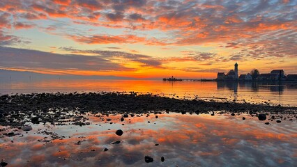 Breathtaking view of a fiery sunset over a tranquil body of water